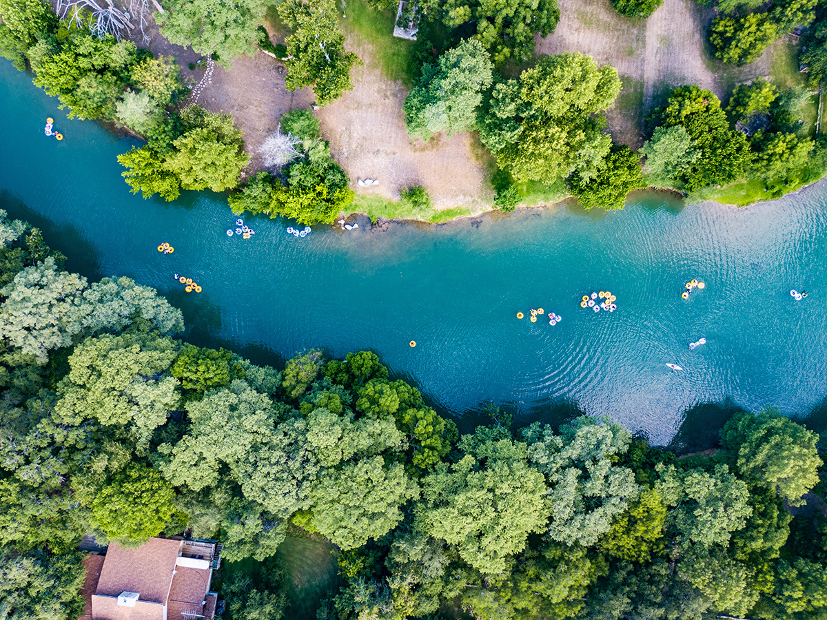 Family walking by the Guadalupe River in New Braunfels TX